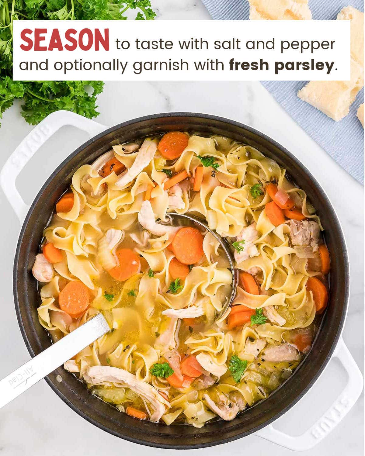 Garnishing Classic Chicken Noodle Soup with fresh parsley and stirring with a spoon.