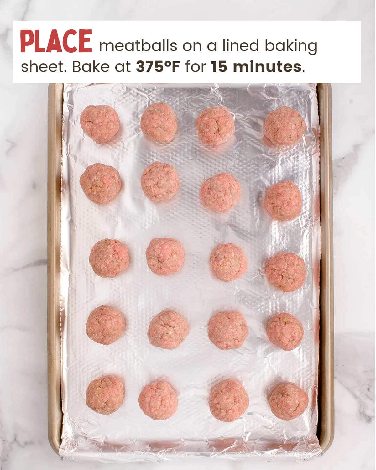 Formed meatballs on a lined baking sheet.