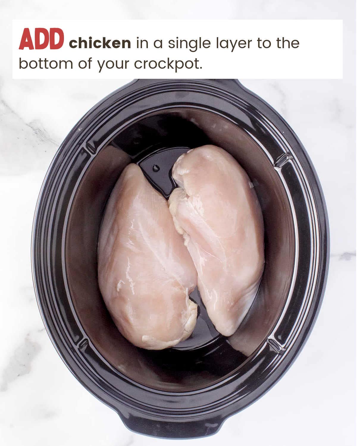 Boneless, skinless chicken breasts in a slow cooker.