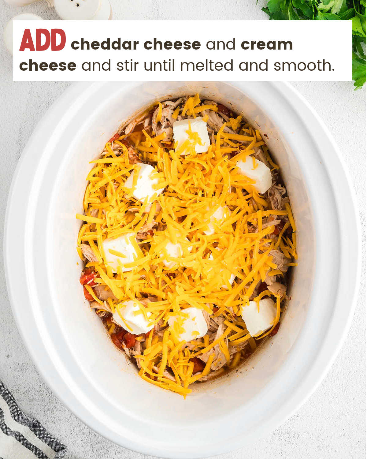 Adding cheddar cheese and cream cheese to slow cooker for Crock-Pot Chicken Spaghetti.