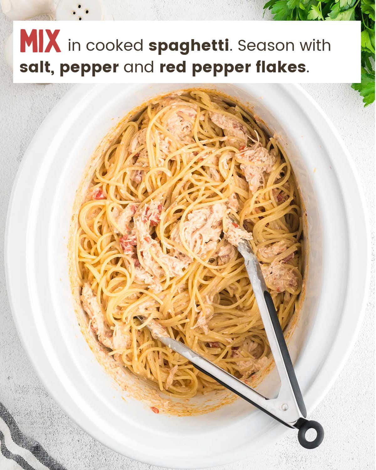 Adding spaghetti to sauce for Crock-Pot Chicken Spaghetti.
