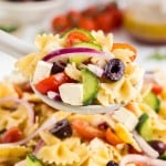 Closeup of a serving spoon filled with freshly made Greek Pasta Salad.