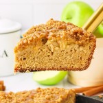 A slice of Appel Crumb Cake on a pie server.