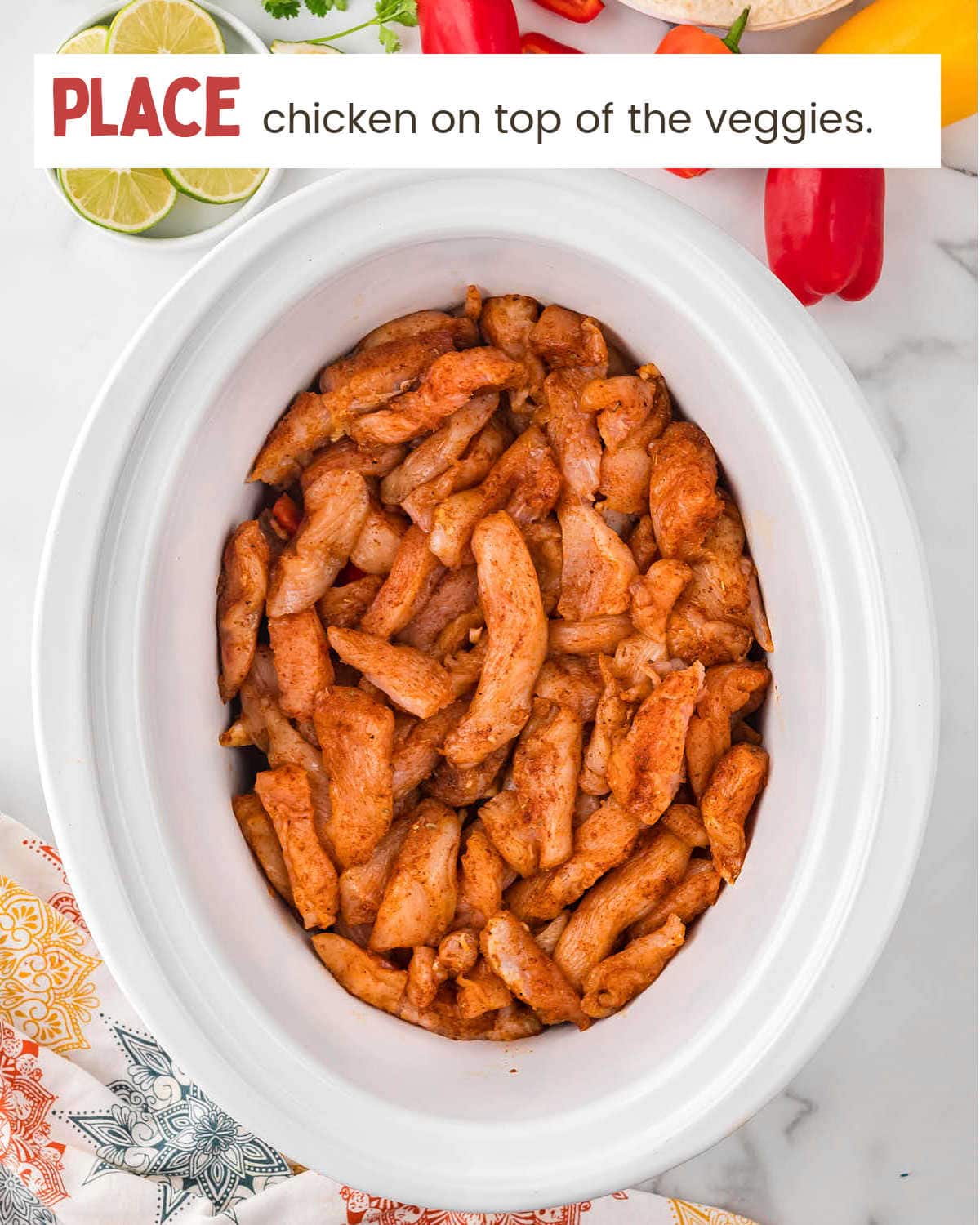 Adding chicken to slow cooker for Crockpot Chicken Fajitas.