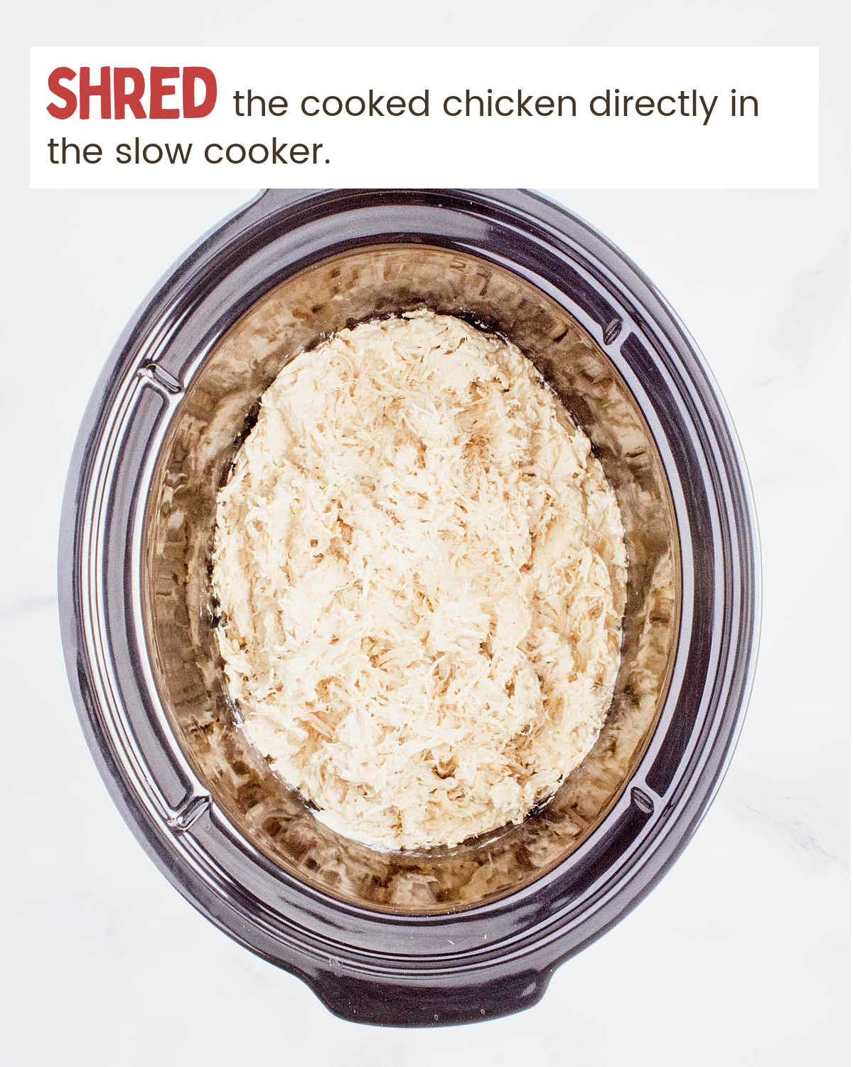 Cooked shredded chicken in Crockpot for Crockpot Crack Chicken.