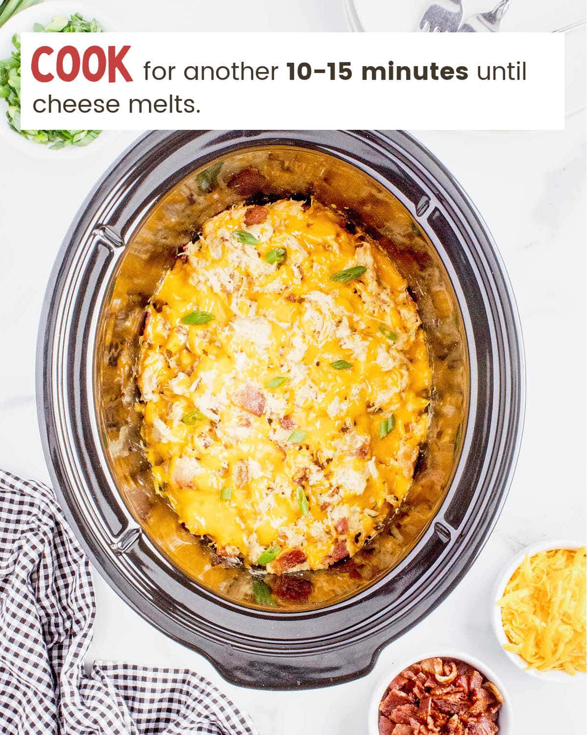 Cooked Crockpot Crack Chicken in a slow cooker with melted cheese.