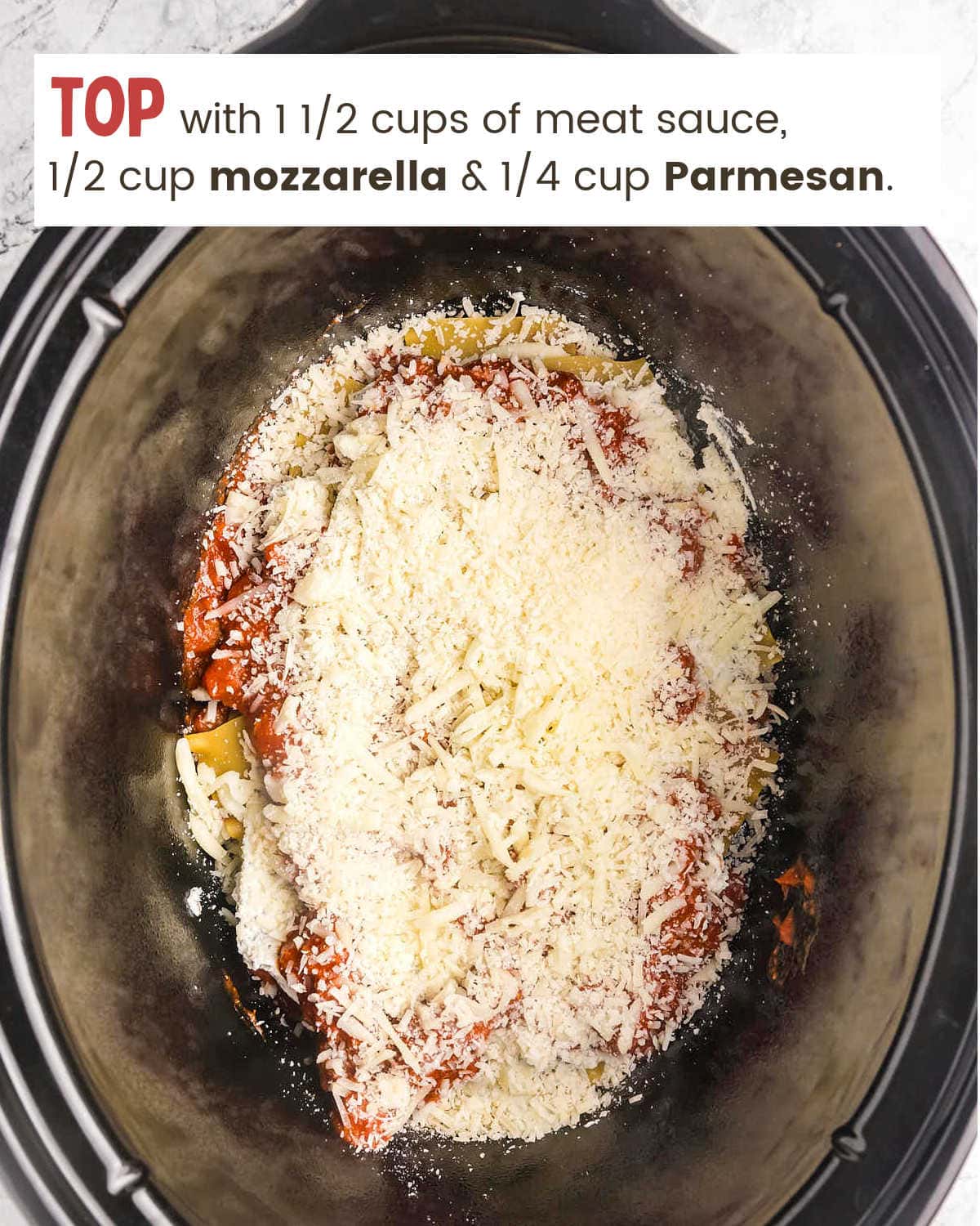 Topping with cheese for Crockpot Lasagna in slow cooker.
