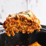 Closeup of a slice of Crockpot Lasagna being lifted out of the slow cooker.