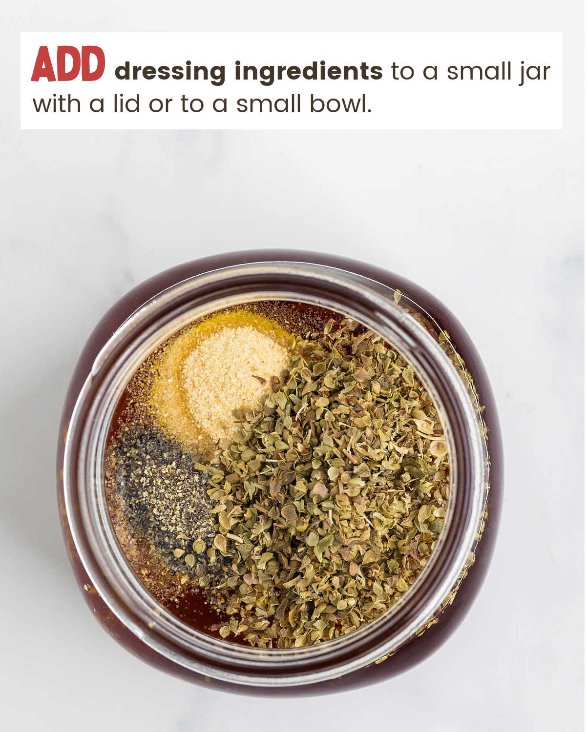Mixing ingredients for Greek Pasta Salad dressing in a mason jar.