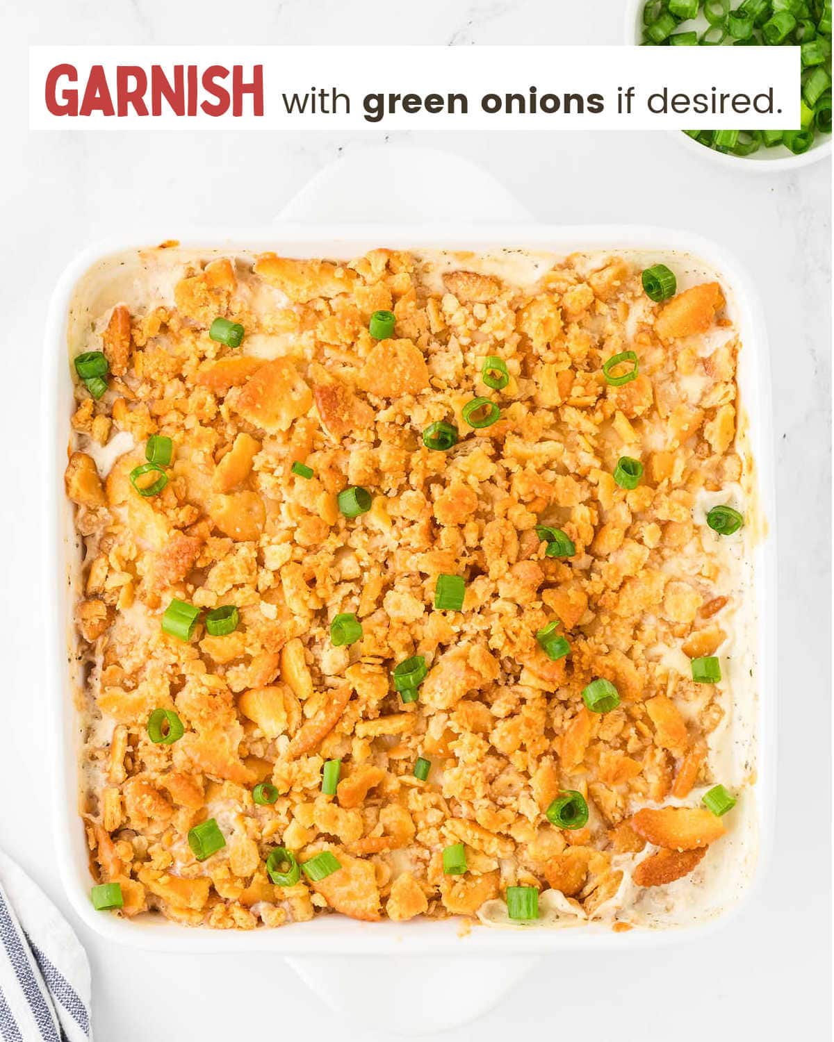 Garnishing Million Dollar Chicken Casserole with green onions.