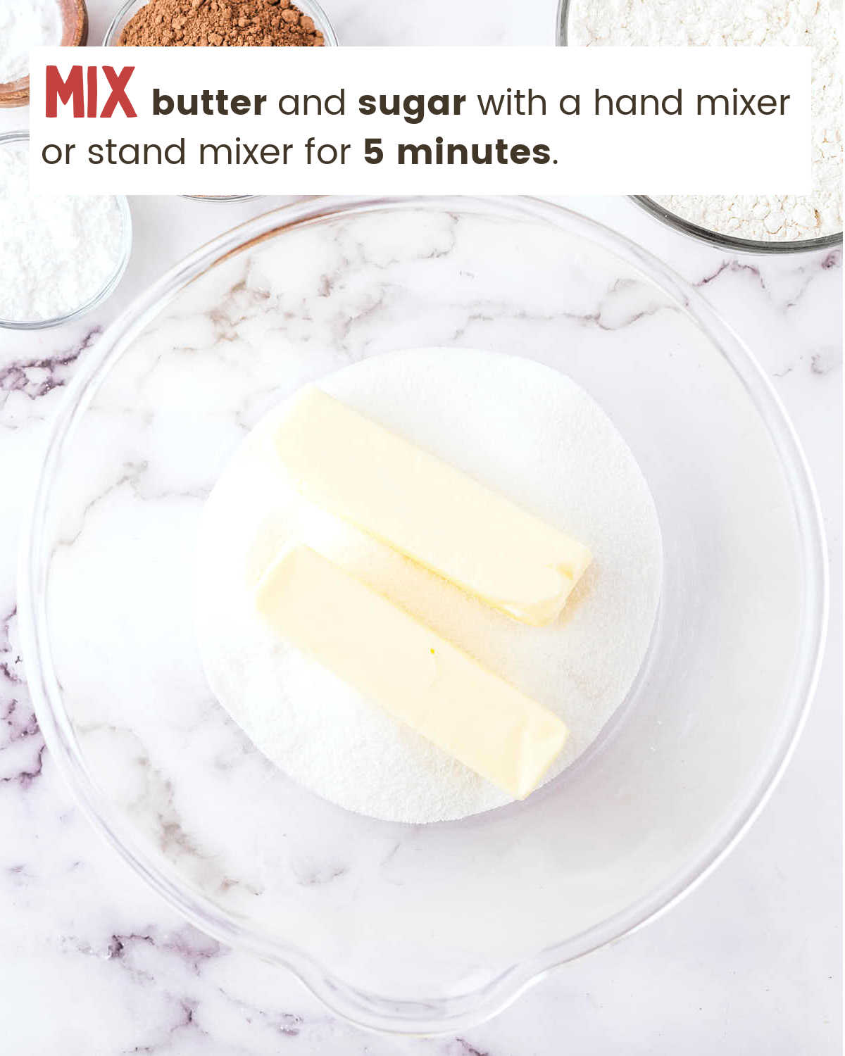 Butter and sugar in a glass bowl for Oreo Sheet Cake.
