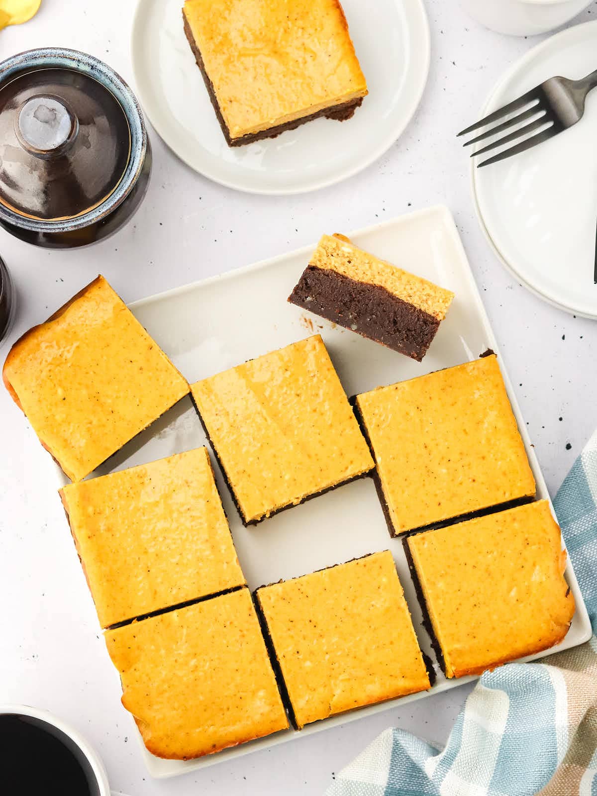 Pumpkin Cheesecake Brownies sliced and ready to be served.