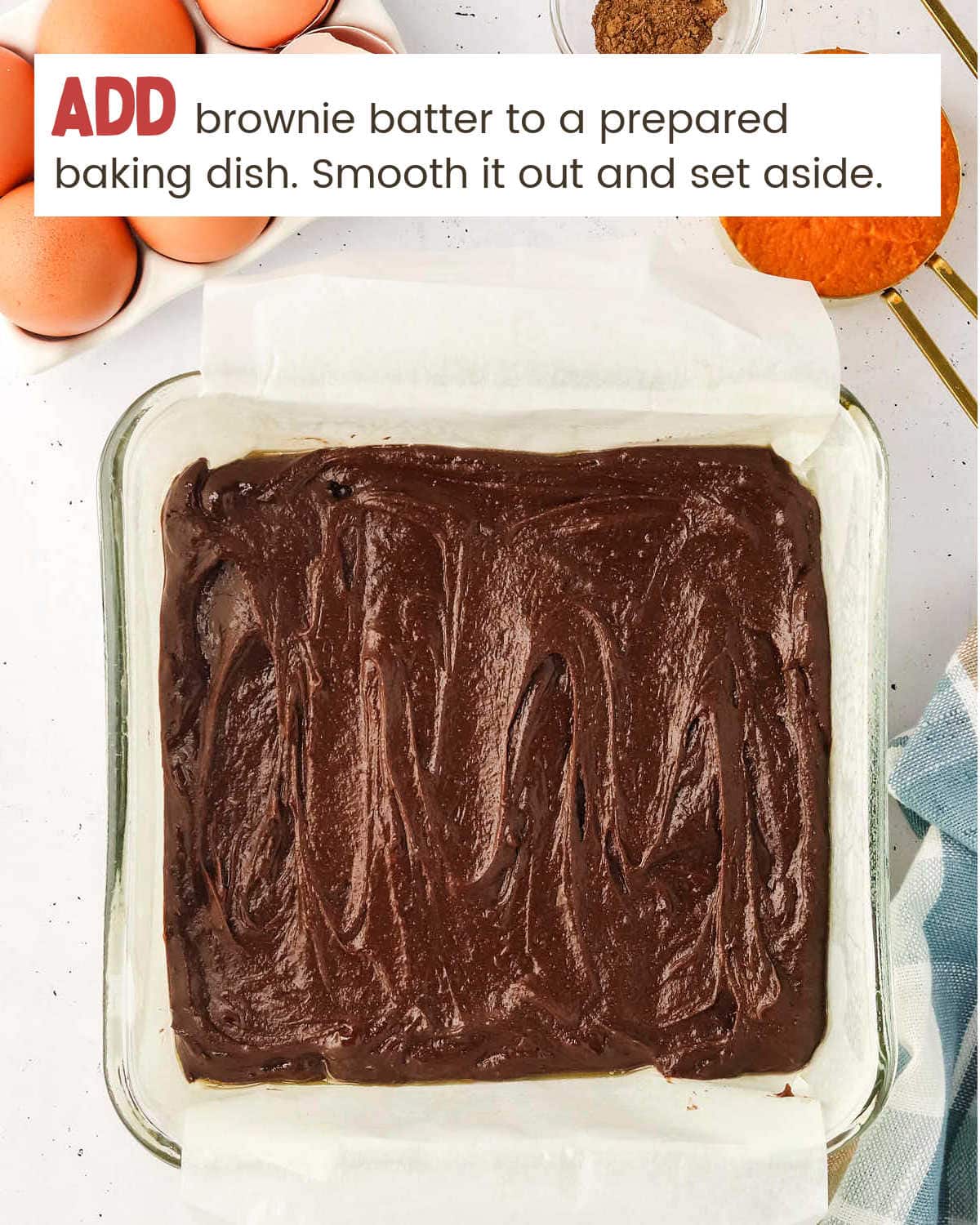 Adding brownie batter to a glass baking dish.