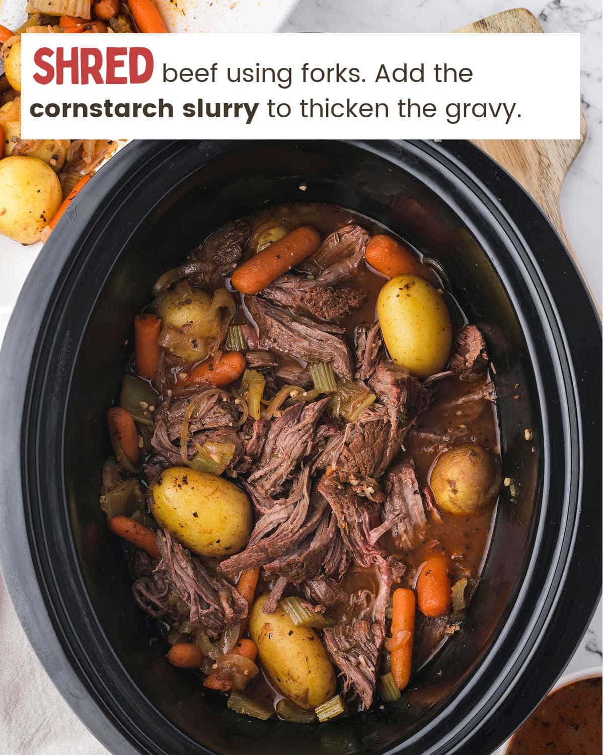 Shredding beef for Slow Cooker Sirloin Tip Roast.