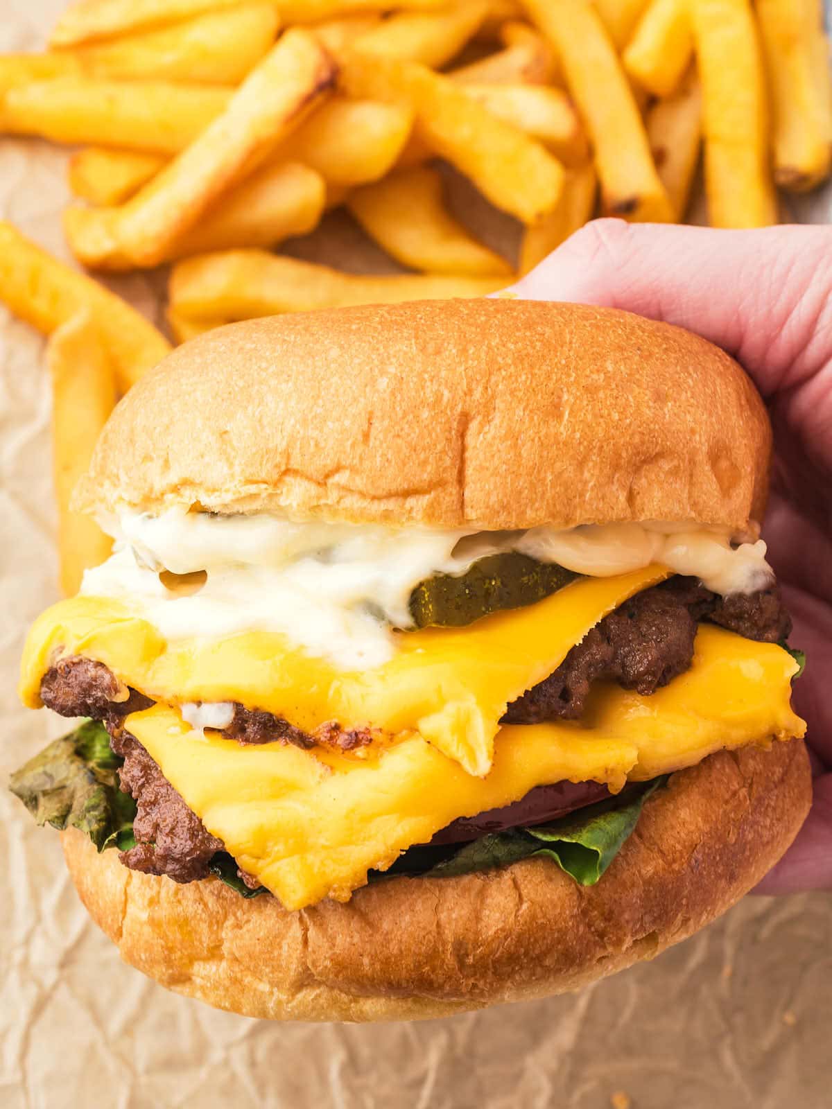 A hand holding up a Smash Burger.