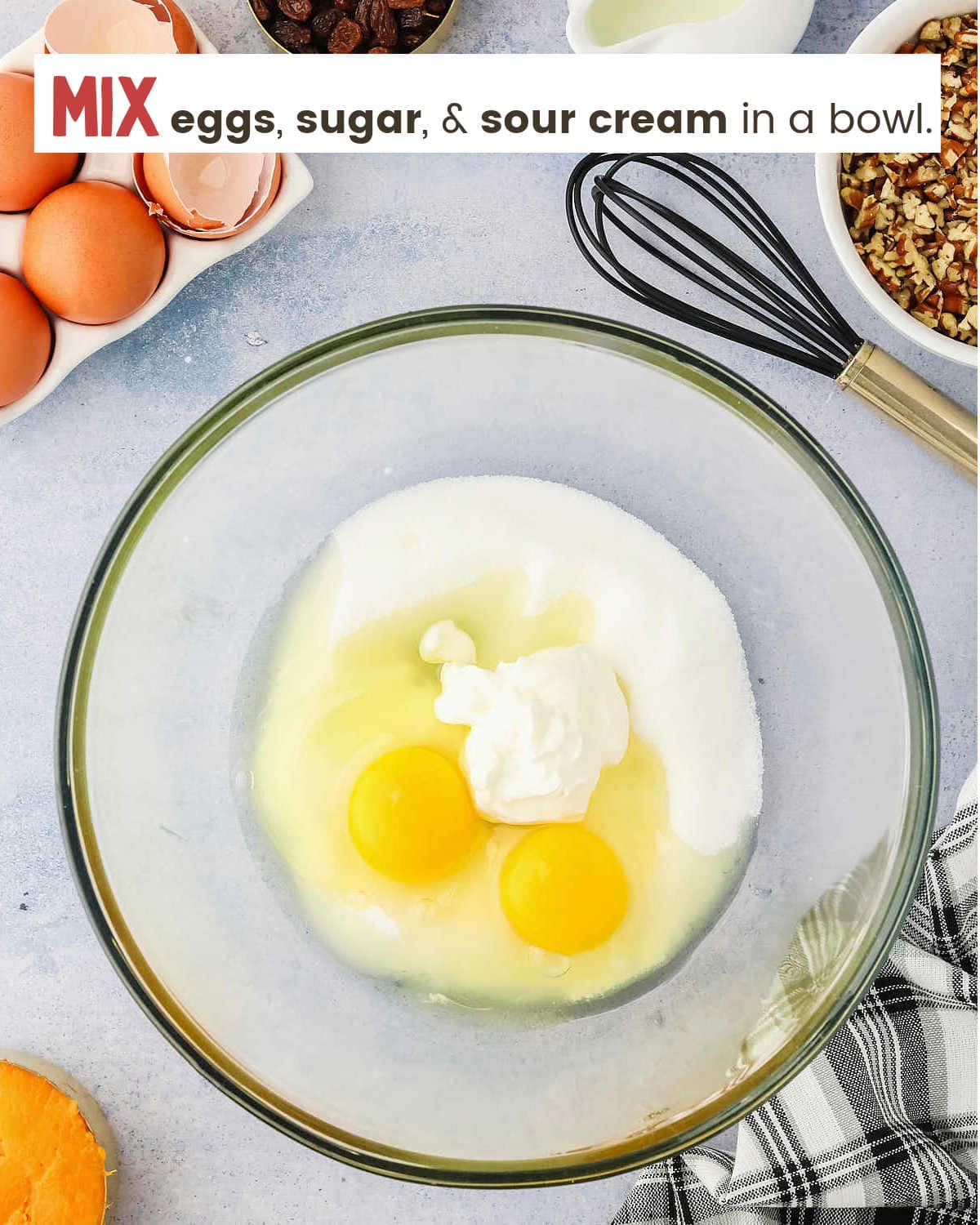 Mixing eggs, sugar and sour cream in a glass bowl for Sweet Potato Bread.