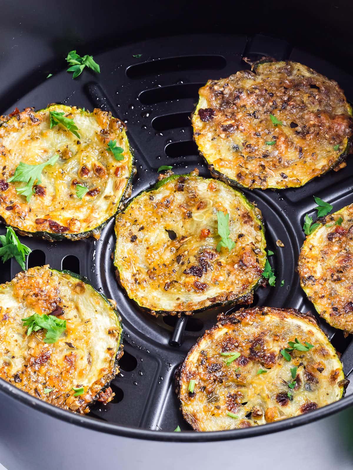 Perfectly air fried Zucchini Chips in an Air Fryer.