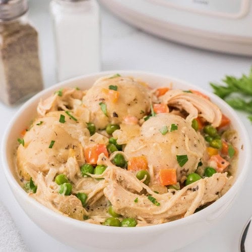 Chicken and Dumpling made in the Crock-Pot served in a white bowl.
