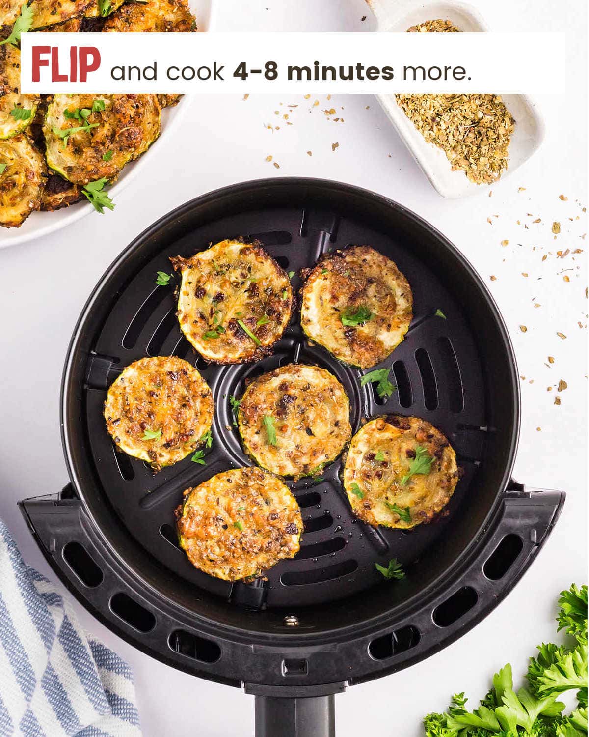 Golden brown Air Fryer Zucchini Chips in air fryer basket.