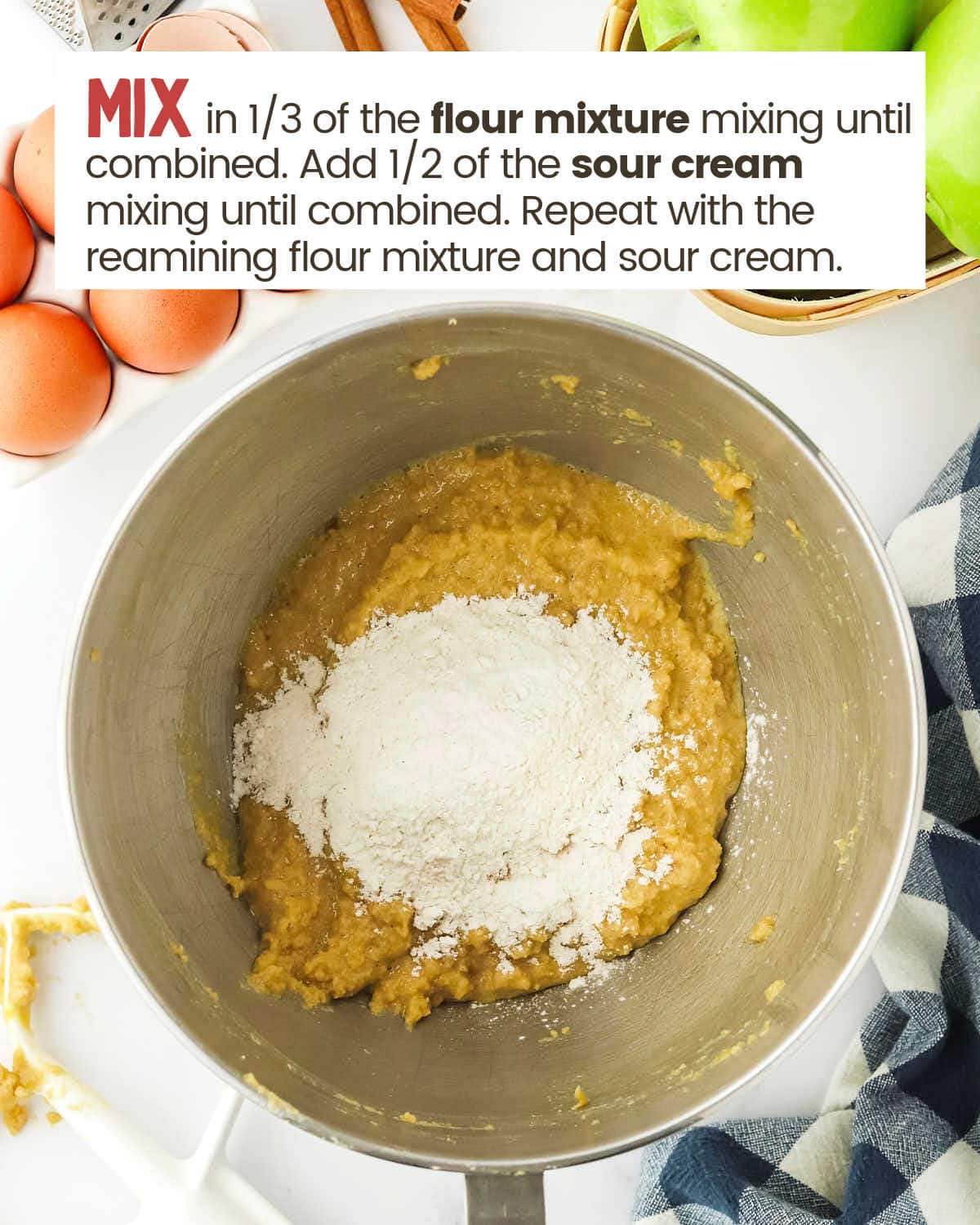 Flour mixture on top of cream ingredients in a bowl.