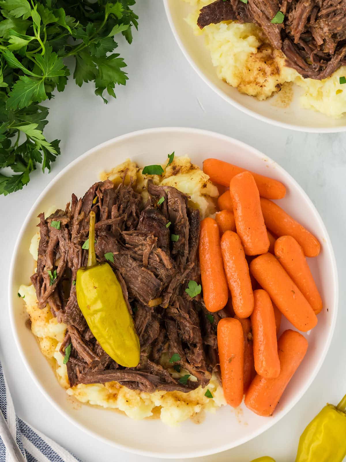 Topdown view of a Mississippi Pot Roast served over mashed potatoes.
