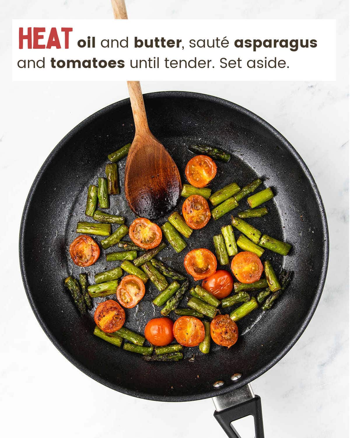 Cooking tomatoes and asparagus in skillet for Shrimp Asparagus Pasta.