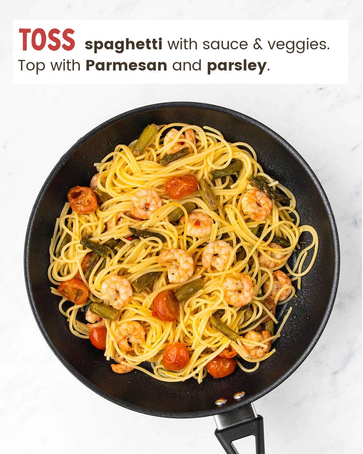 Tossing spaghetti with veggies for Shrimp Asparagus Pasta.