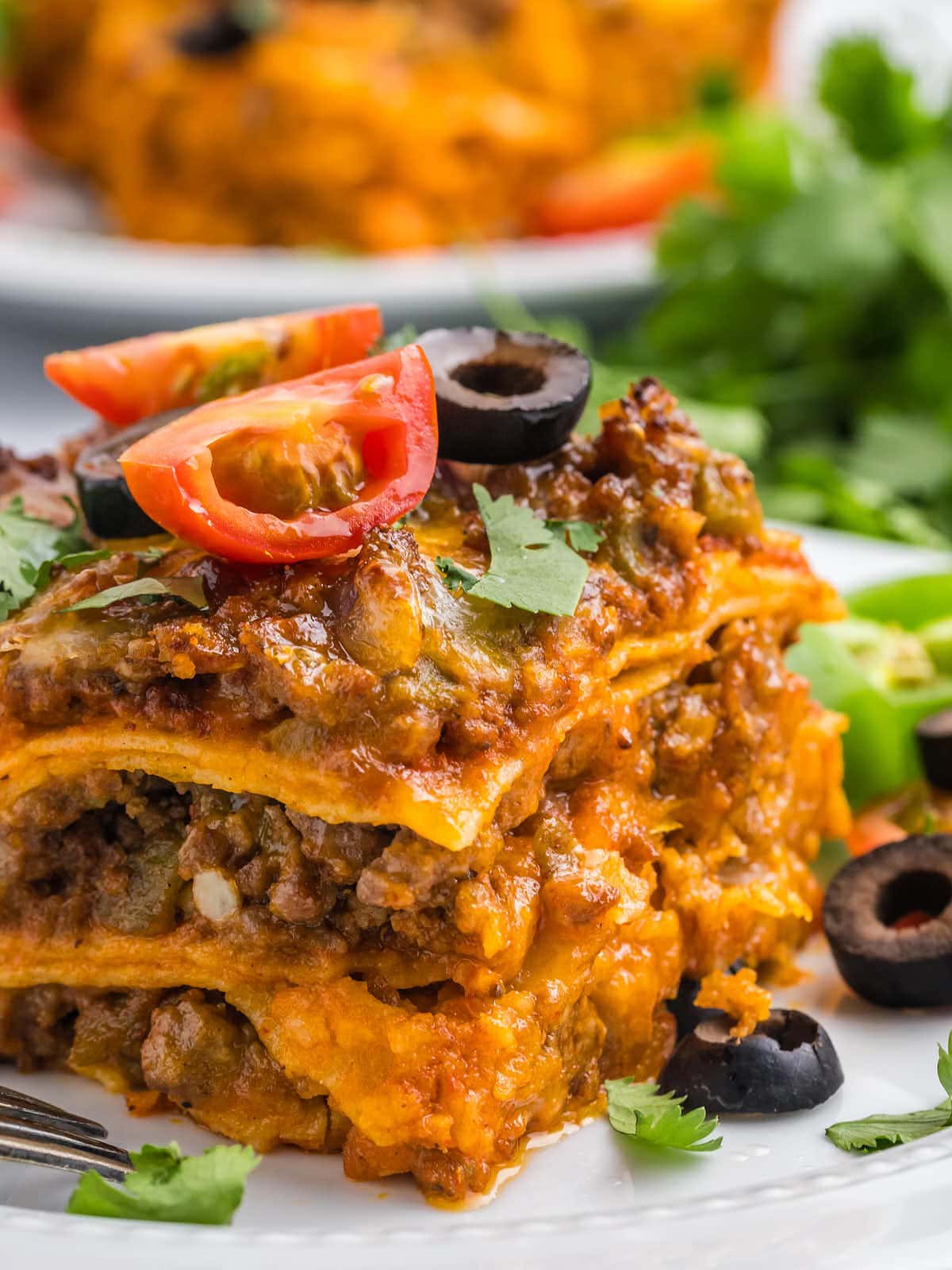 Closeup of a slice of Beef Enchilada showing all the layers.