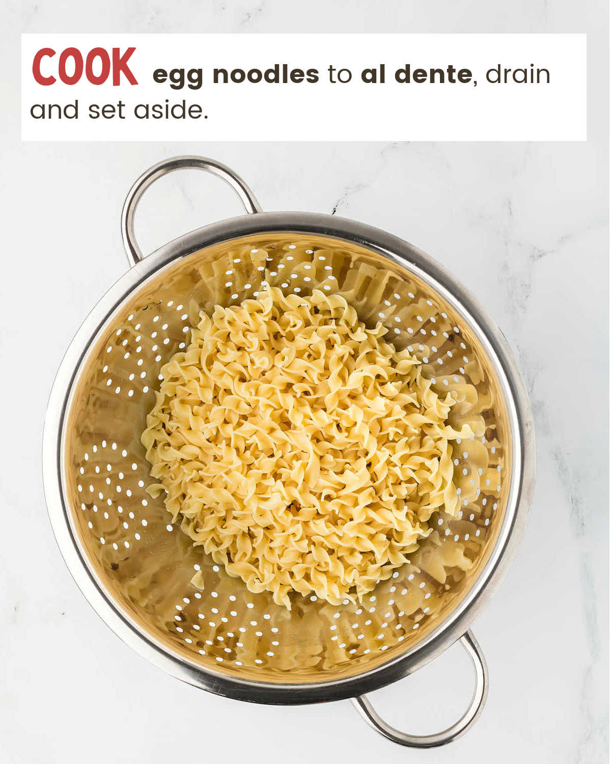 Cooked egg noodles in a strainer for Tuna Casserole.