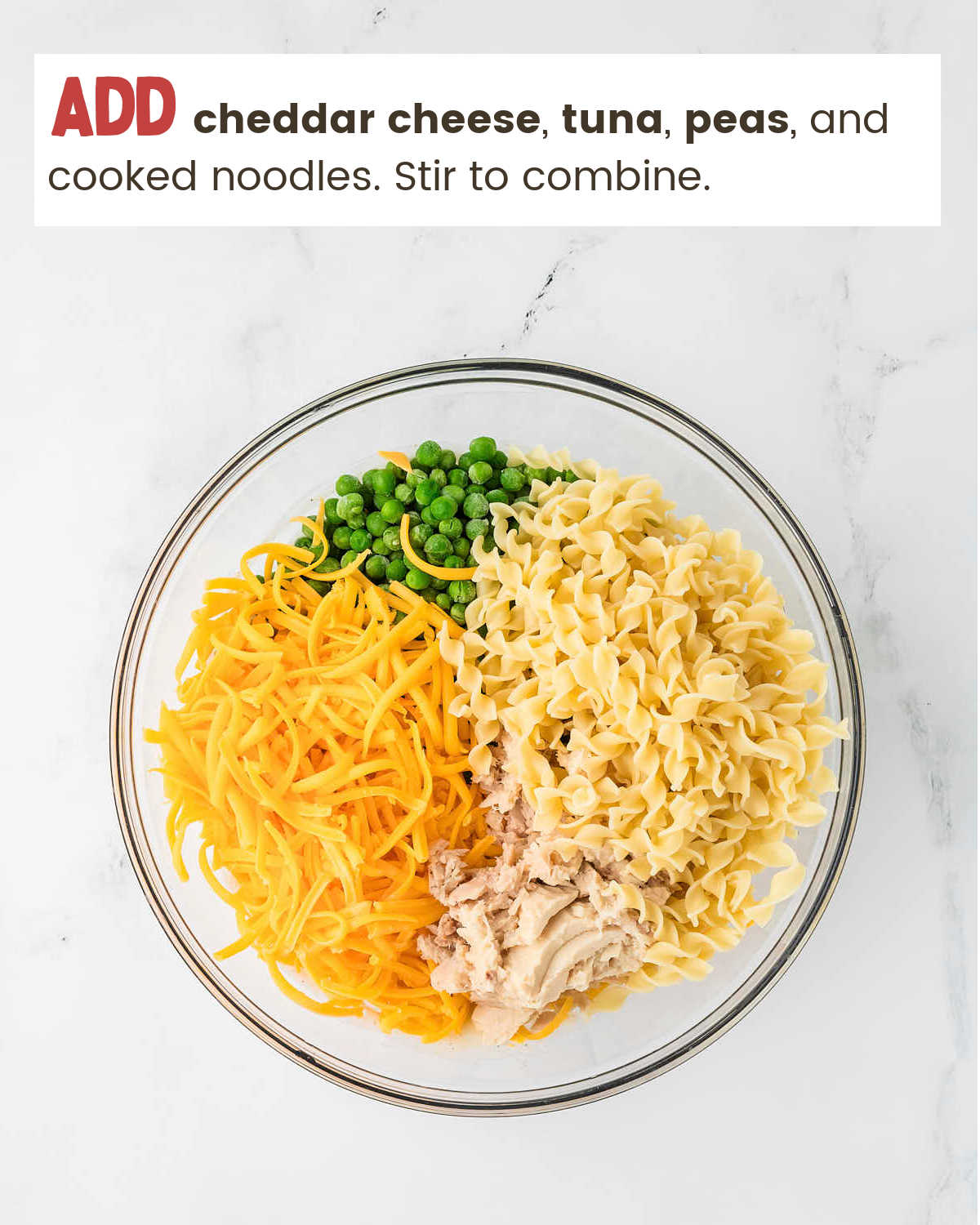Mixing cheese, noodles, peas and tuna for Tuna Casserole.