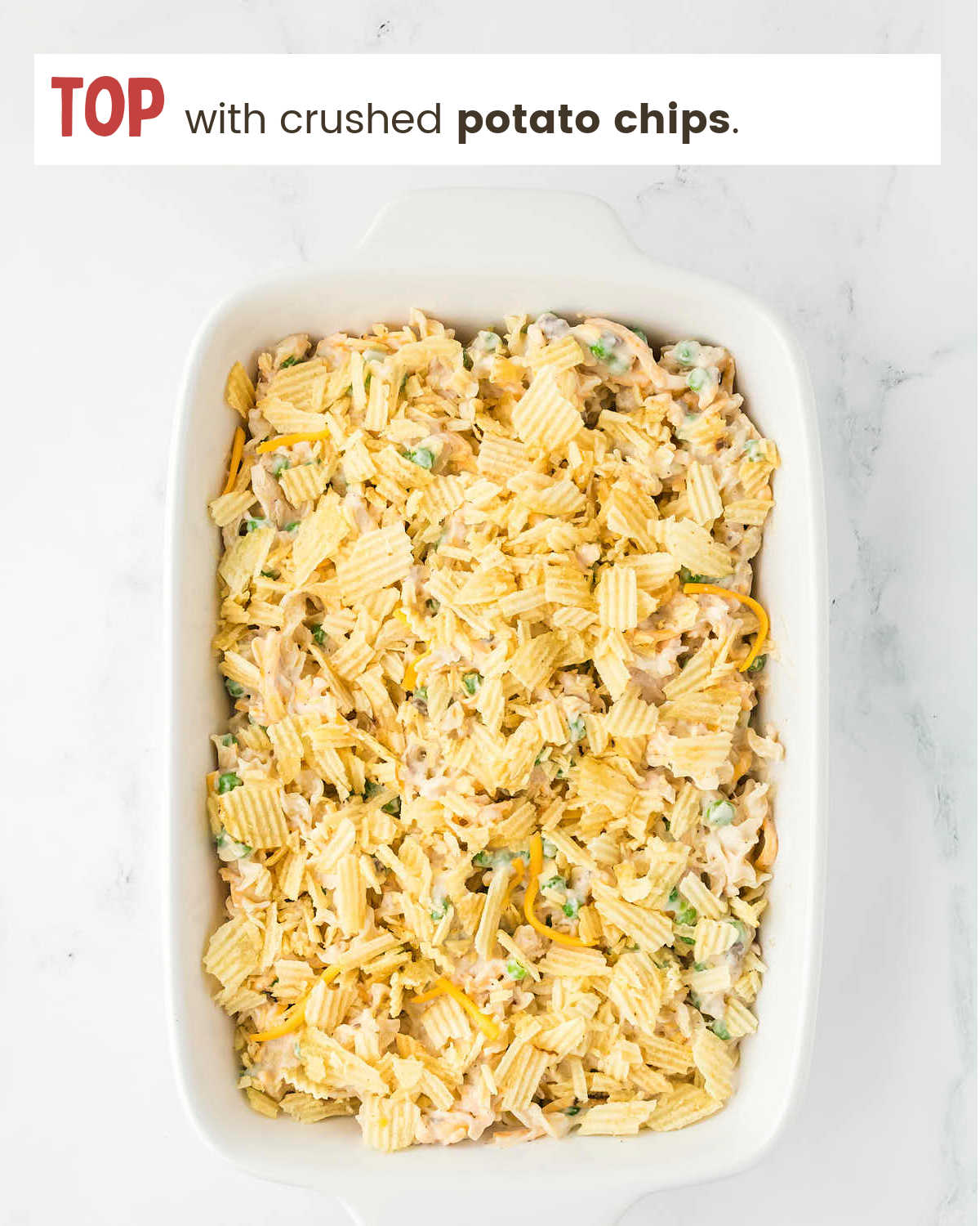 Topping Tuna Casserole with crushed potato chips.