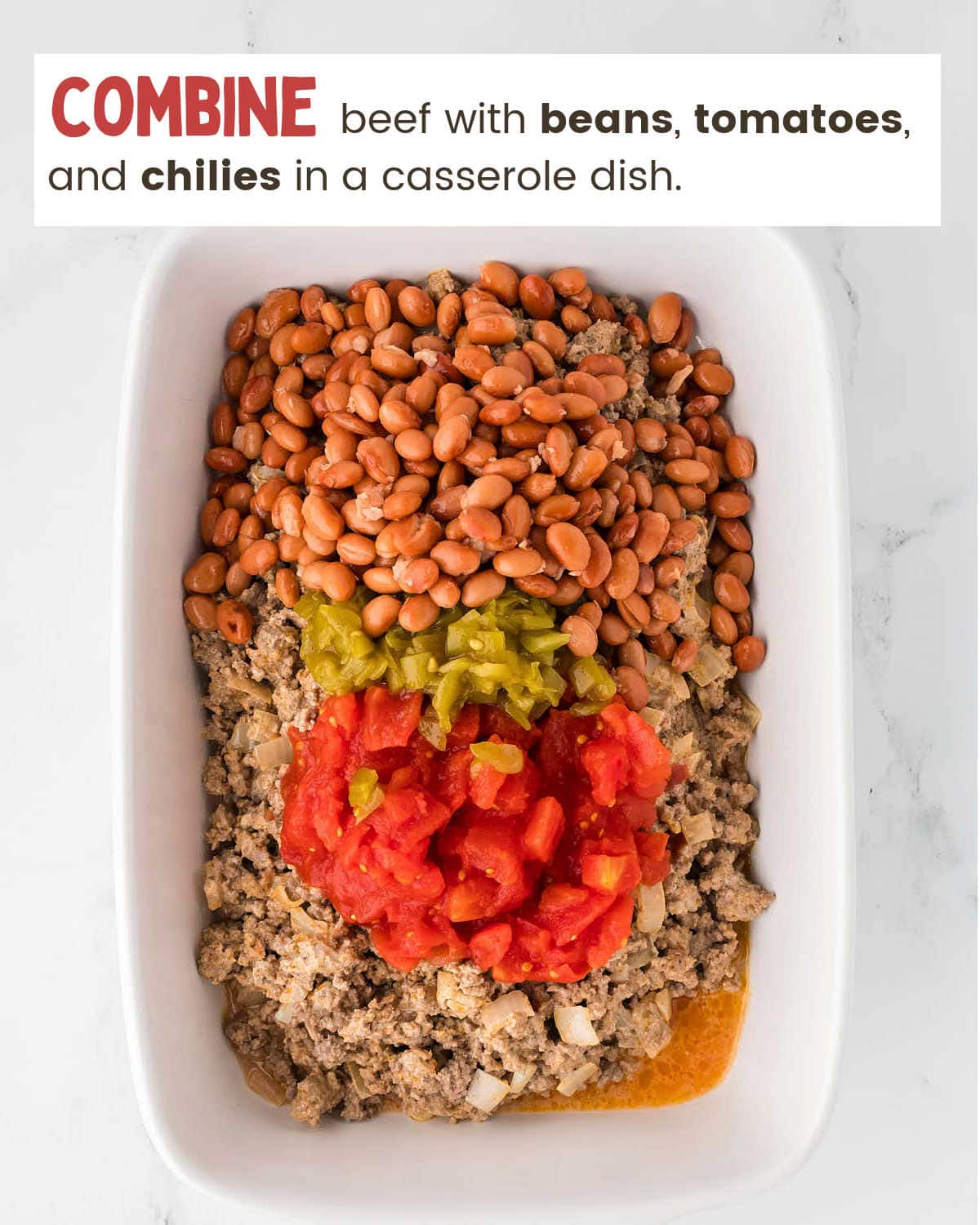 Adding beef and veggies to baking dish for Walking Taco Casserole.