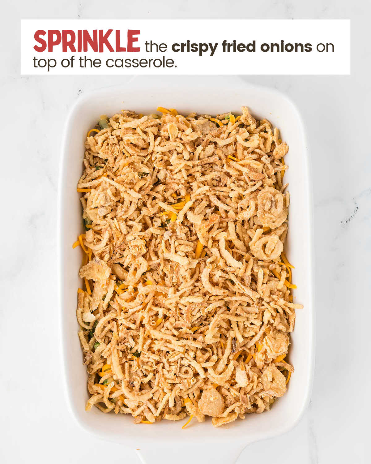 Crispy fried onions on top of green bean casserole in a casserole dish.