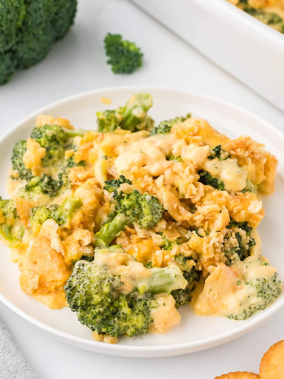 Cheesy Broccoli Casserole served on a white plate.