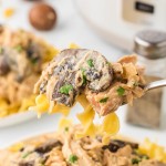 A fork filled with Slow Cooker Chicken Stroganoff served over pasta.