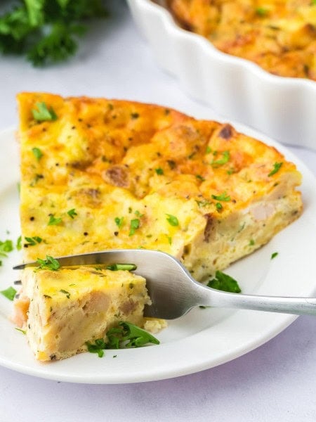 A slice of Thanksgiving Quiche on a white plate.