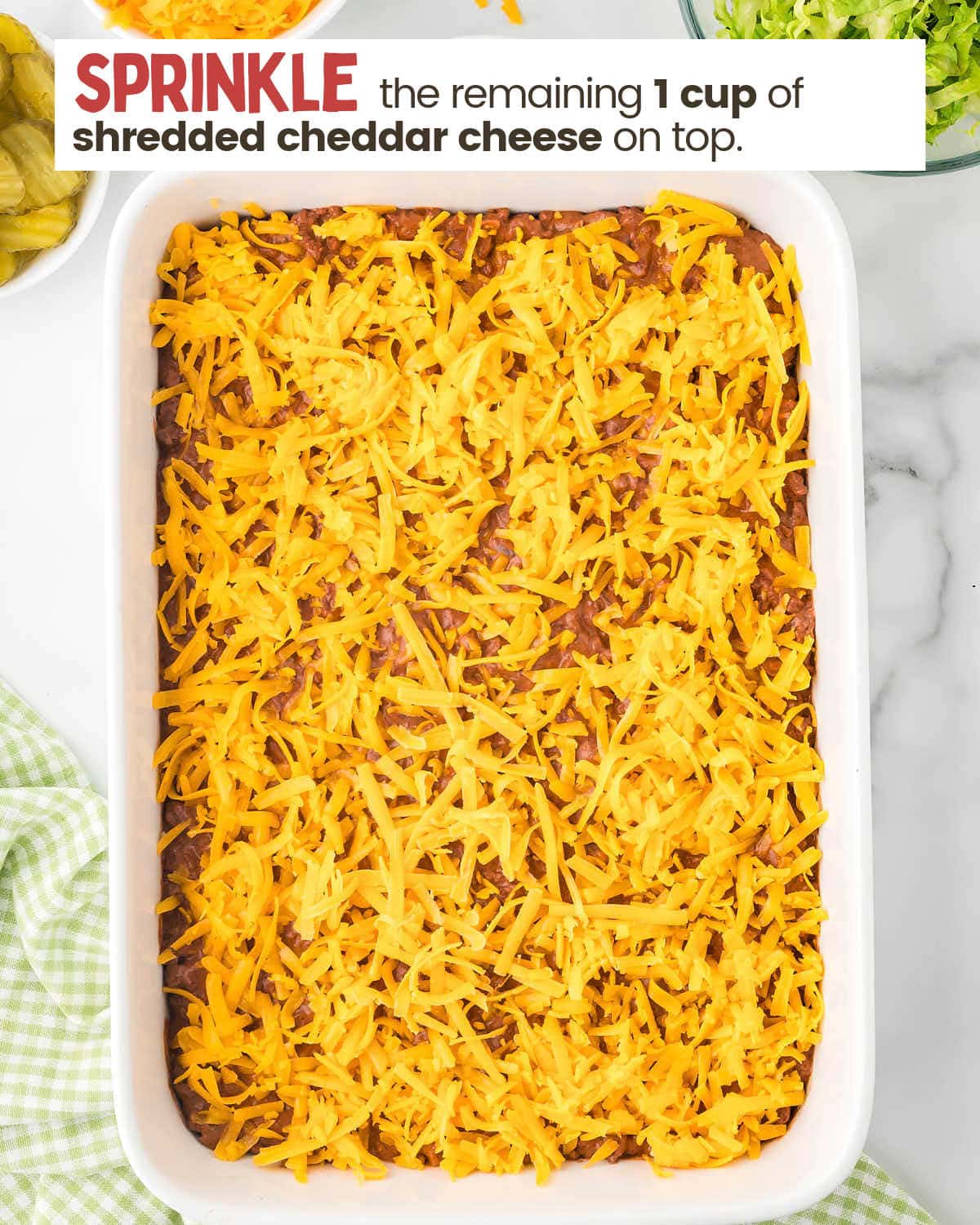 Cooked ground beef mixture in a 9 x 13" casserole dish topped with cheese.