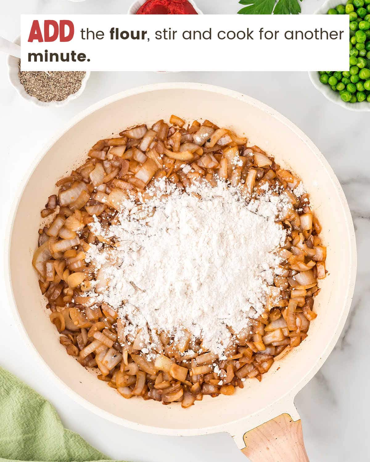 Flour on top of Onions and garlic in a skillet.