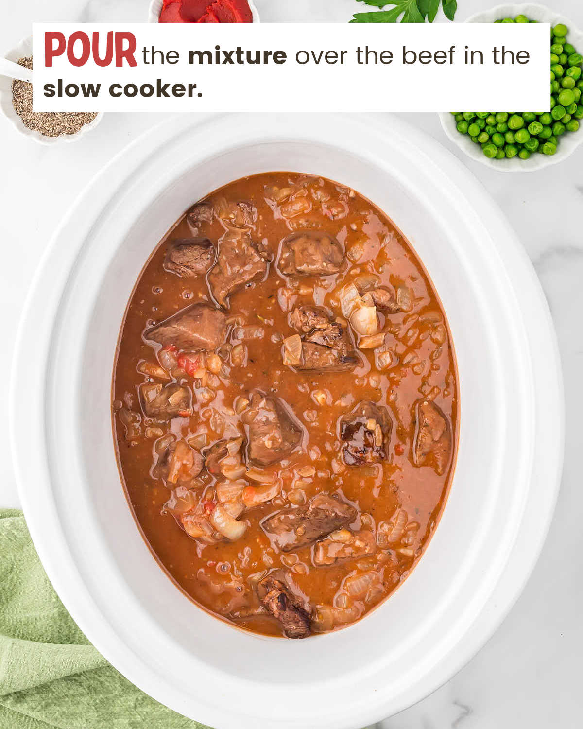 Broth over browned meat in a slow cooker.