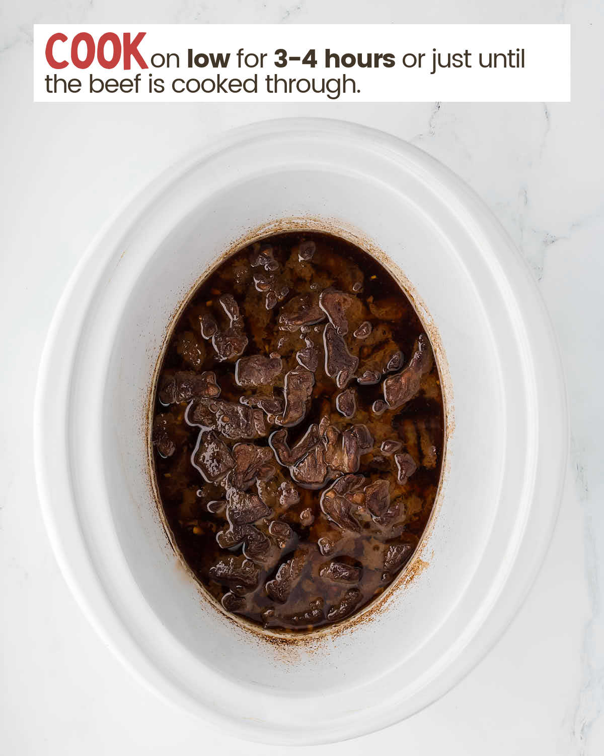 Beef and sauce in a slow cooker.