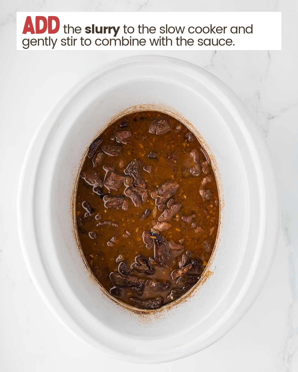 Beef and sauce in a slow cooker.