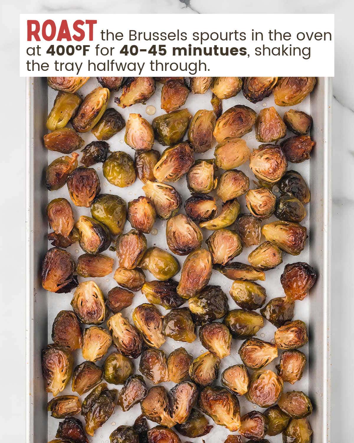 Brussels sprouts are on a baking tray with text instructions on how to bake them..