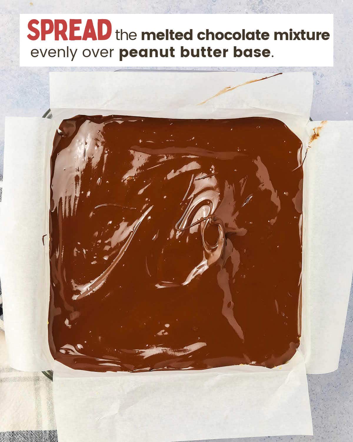 The chocolate layer of peanut butter bars in a dish.