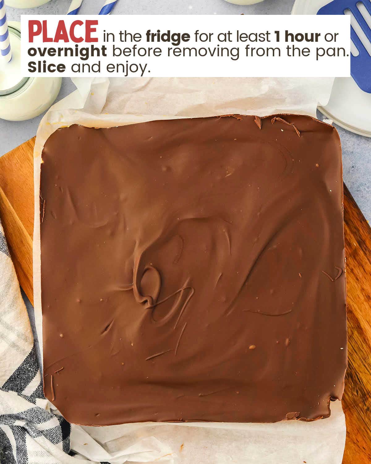 Peanut butter bars in a dish showing the chocolate layer on top.
