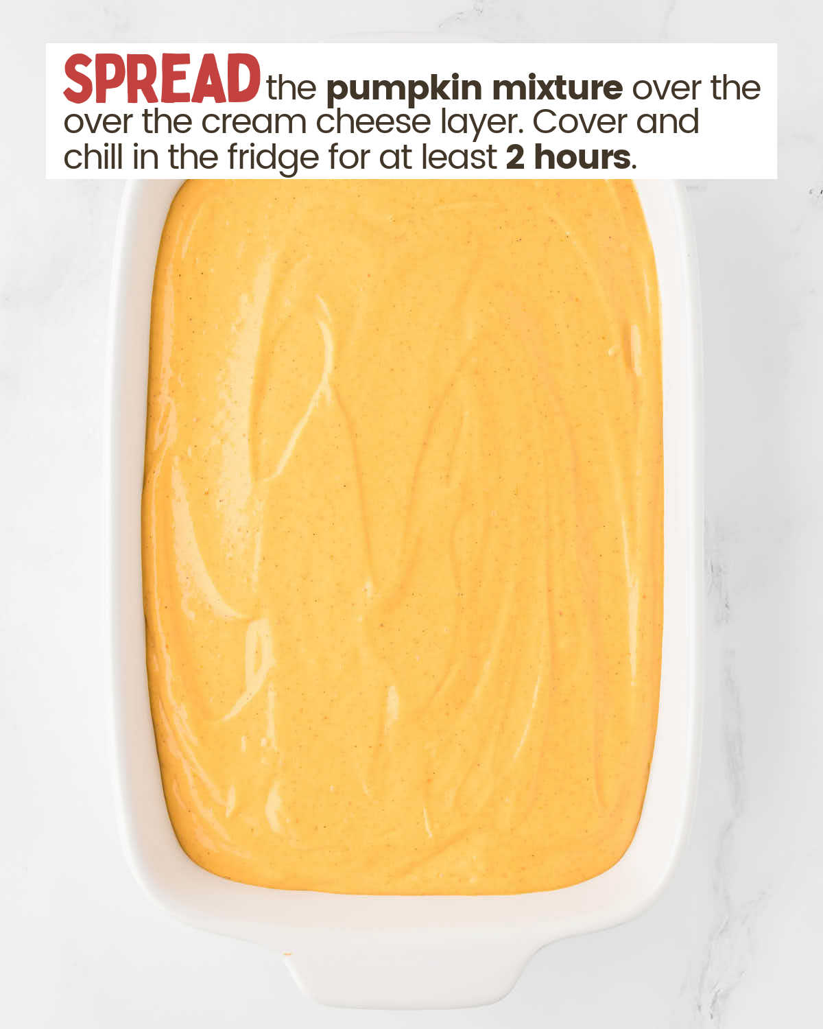 Pumpkin mixture spread as a layer over other layers in a baking dish.