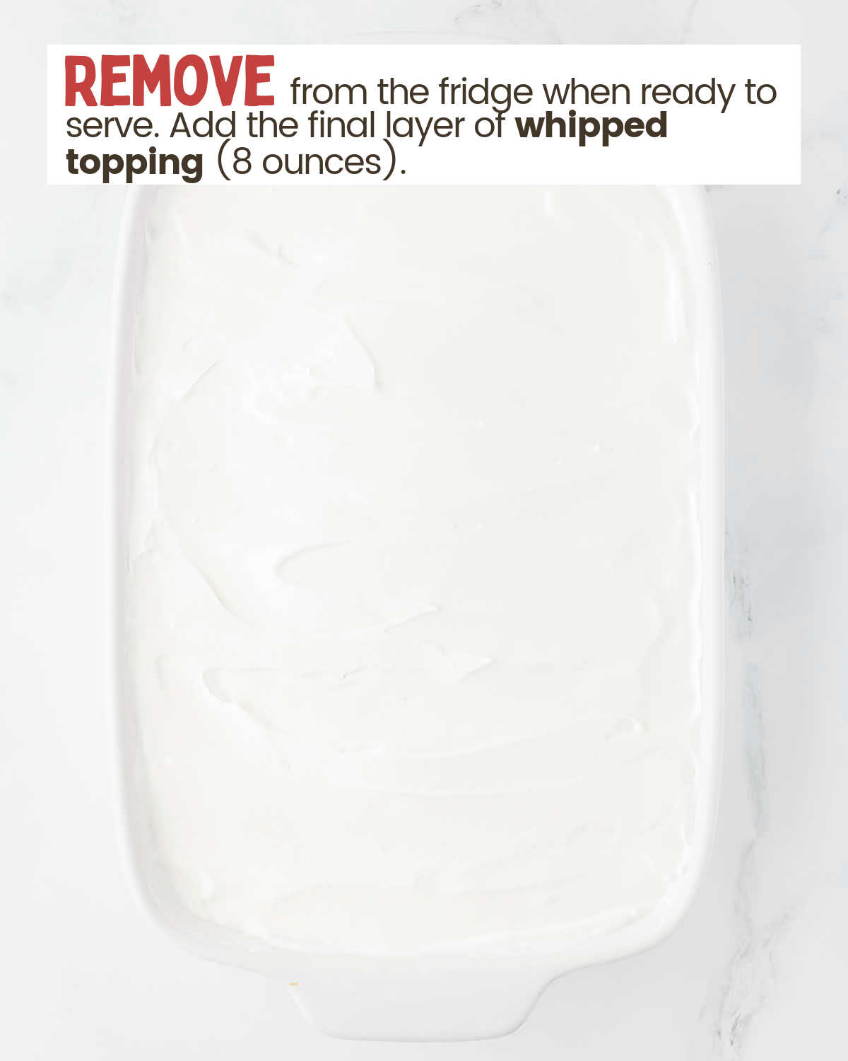 Whipped topping spread as a layer over other layers in a baking dish.