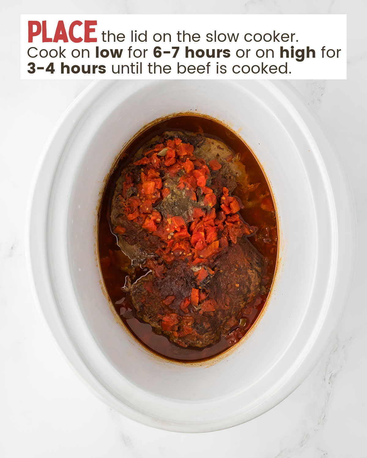 A top-down view of a slow cooker with ingredients for taco meat.