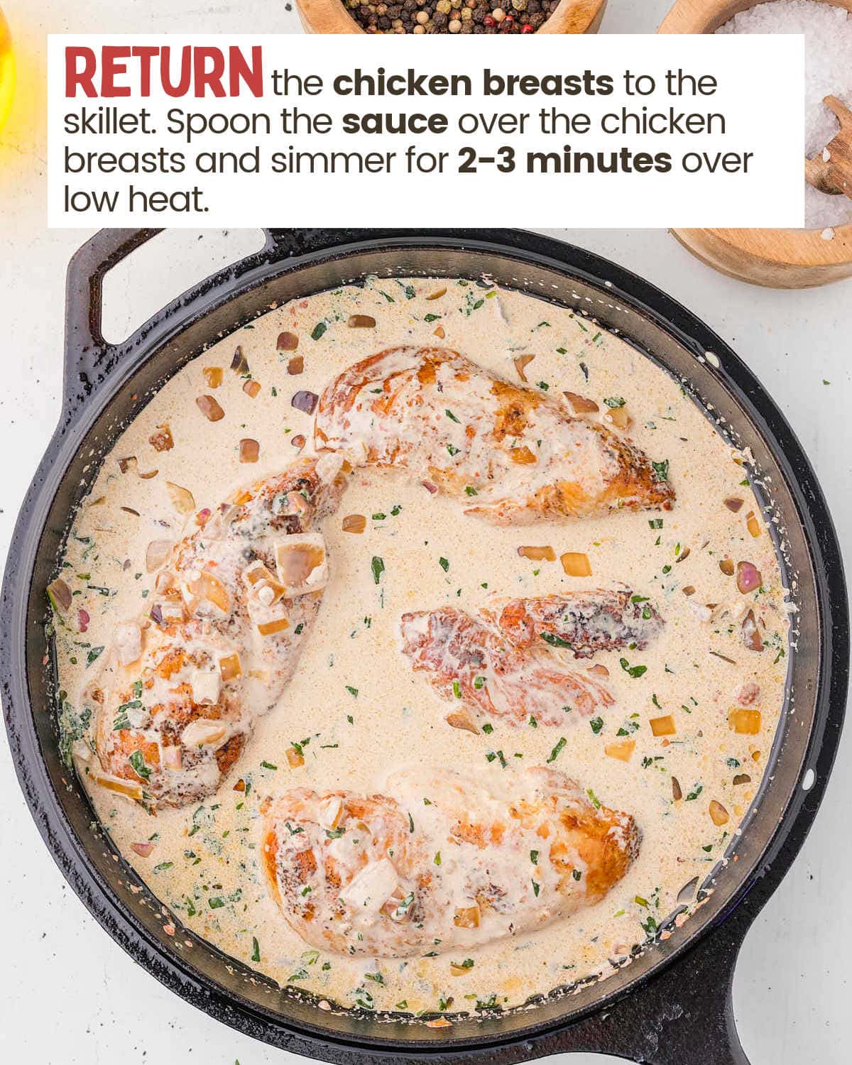 Tarragon chicken in a skillet with sauce.