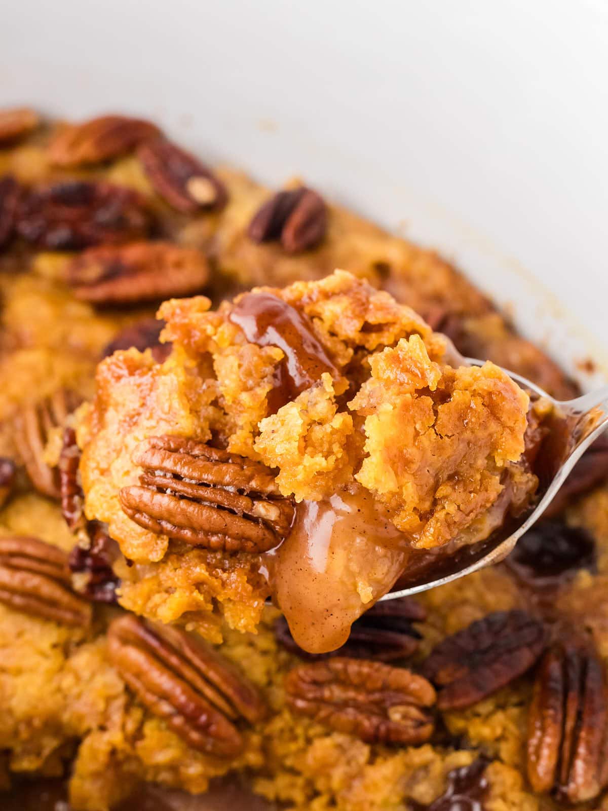 Closeup of spoonful an Apple Dump Cake in the Crockpot.