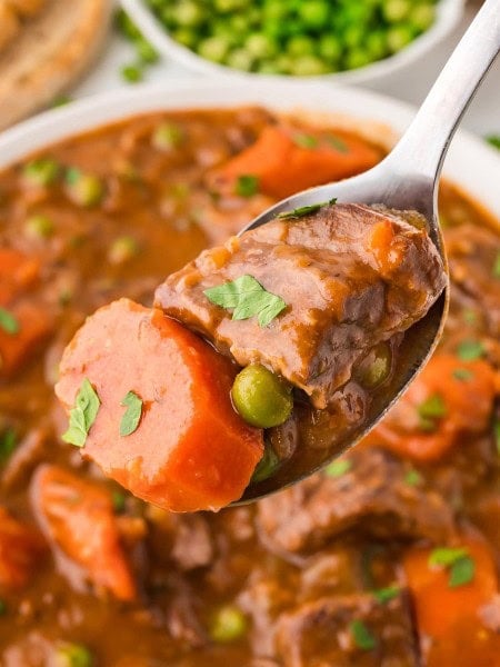 Closeup of a serving spoon filled with Crockpot Beef Stew.